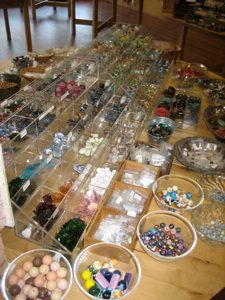 Assorted beads displayed in trays and bowls.