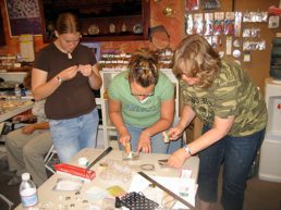 People crafting together at a workshop table.