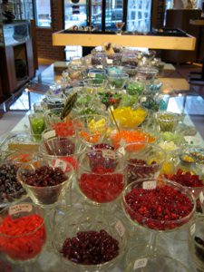 Colorful candy display in glass bowls.