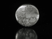 Silver coin with embossed maple leaves.