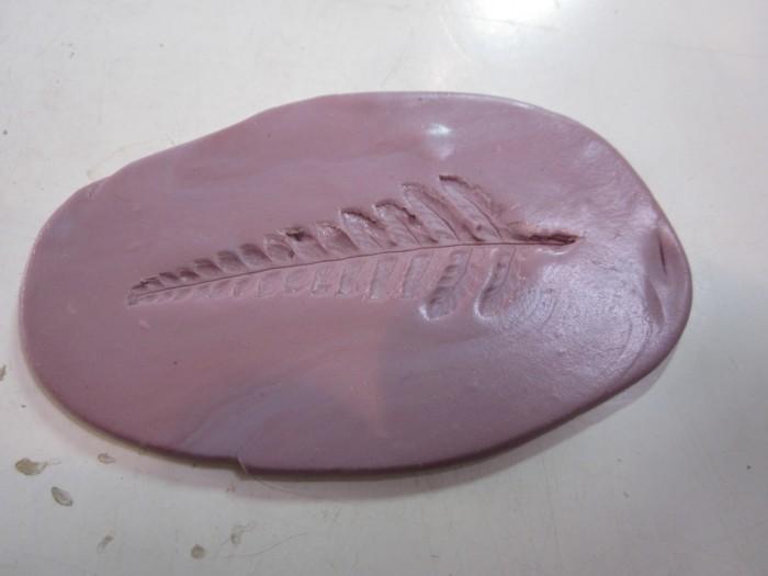 Leaf imprint in purple modeling clay.