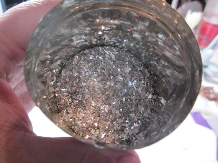 Metallic flakes inside a small container.