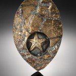 Gold textured pendant with star design.
