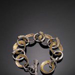 Gold and silver bracelet on black background.