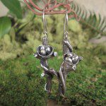 Silver earrings with nature-inspired design.
