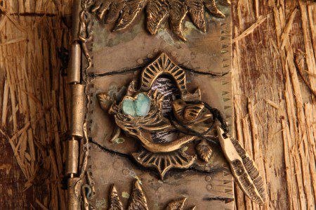 Ornate rustic journal with metal embellishments.