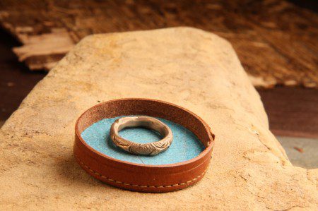 Carved ring in a leather tray.