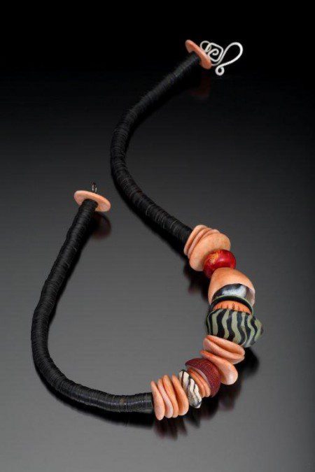 Colorful beaded necklace on black background.