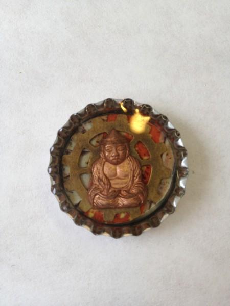 Bottle cap with Buddha figure inside.