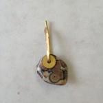 Stone pendant with a gold hook.