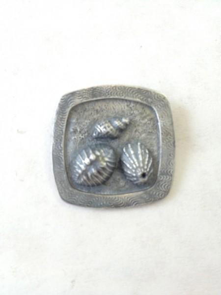 Square button with three shell designs.