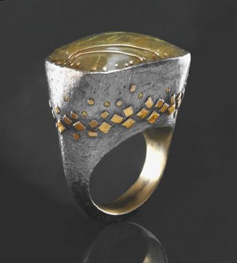 Gold and silver ring with patterned design.