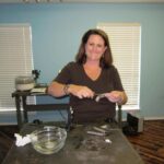 Woman crafting jewelry in a workshop.