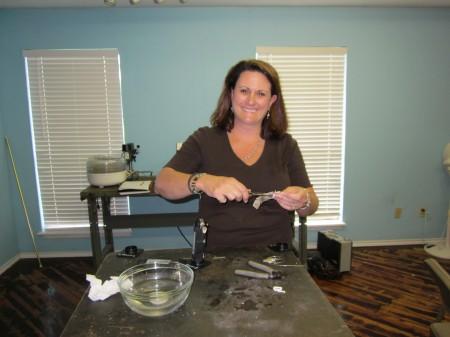 Woman crafting jewelry in a workshop.