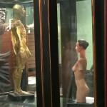 Medical models displayed in glass cabinet.