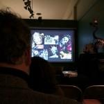 Audience watching a presentation with animal images.