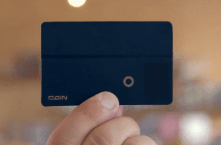 Person holding a black card with logo.