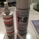 Rust remover and lubricant spray on table.