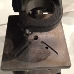 Metallic machine part with circular opening.