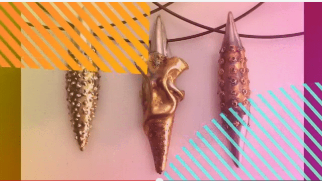 Three decorative pendant necklaces with colorful stripes.