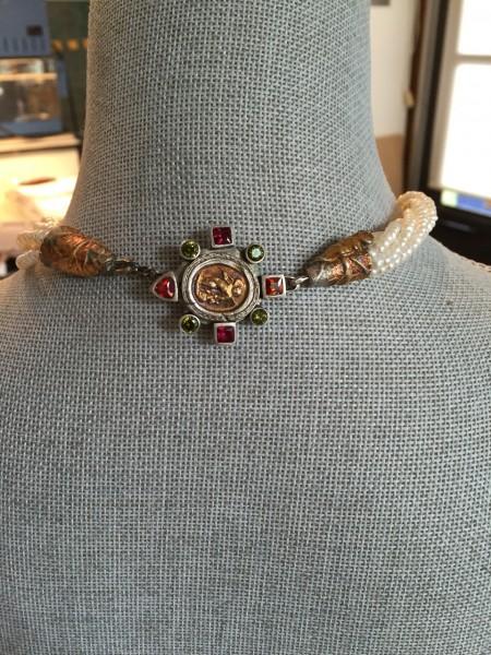 Ornate choker necklace on a mannequin.