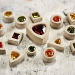 Colorful gemstones in various shapes on table.