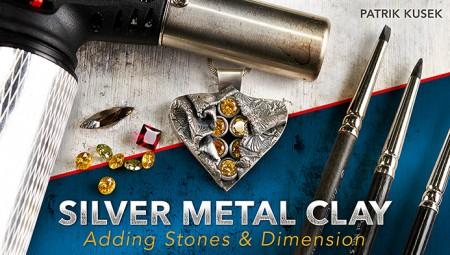 Silver clay jewelry tools and stones display.