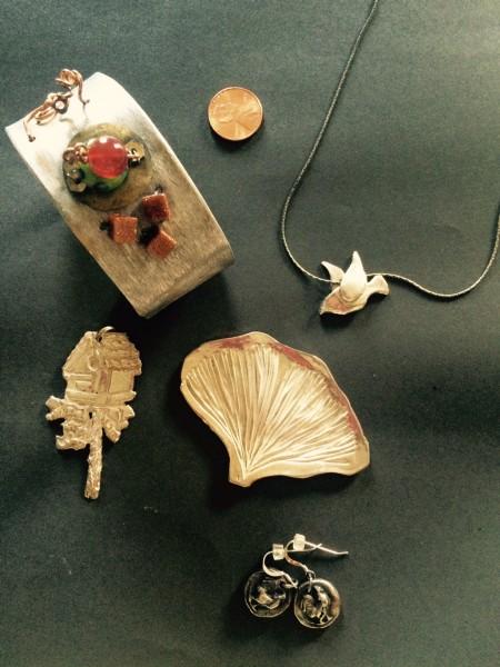 Jewelry pieces arranged on a dark surface.