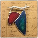 Abstract jewelry piece on handwritten paper background.