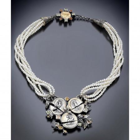 Pearl necklace with intricate coin pendant design.