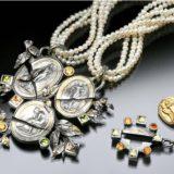 Pearl necklaces with ornate silver pendants.
