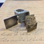 Ring with hidden tiny book inside.
