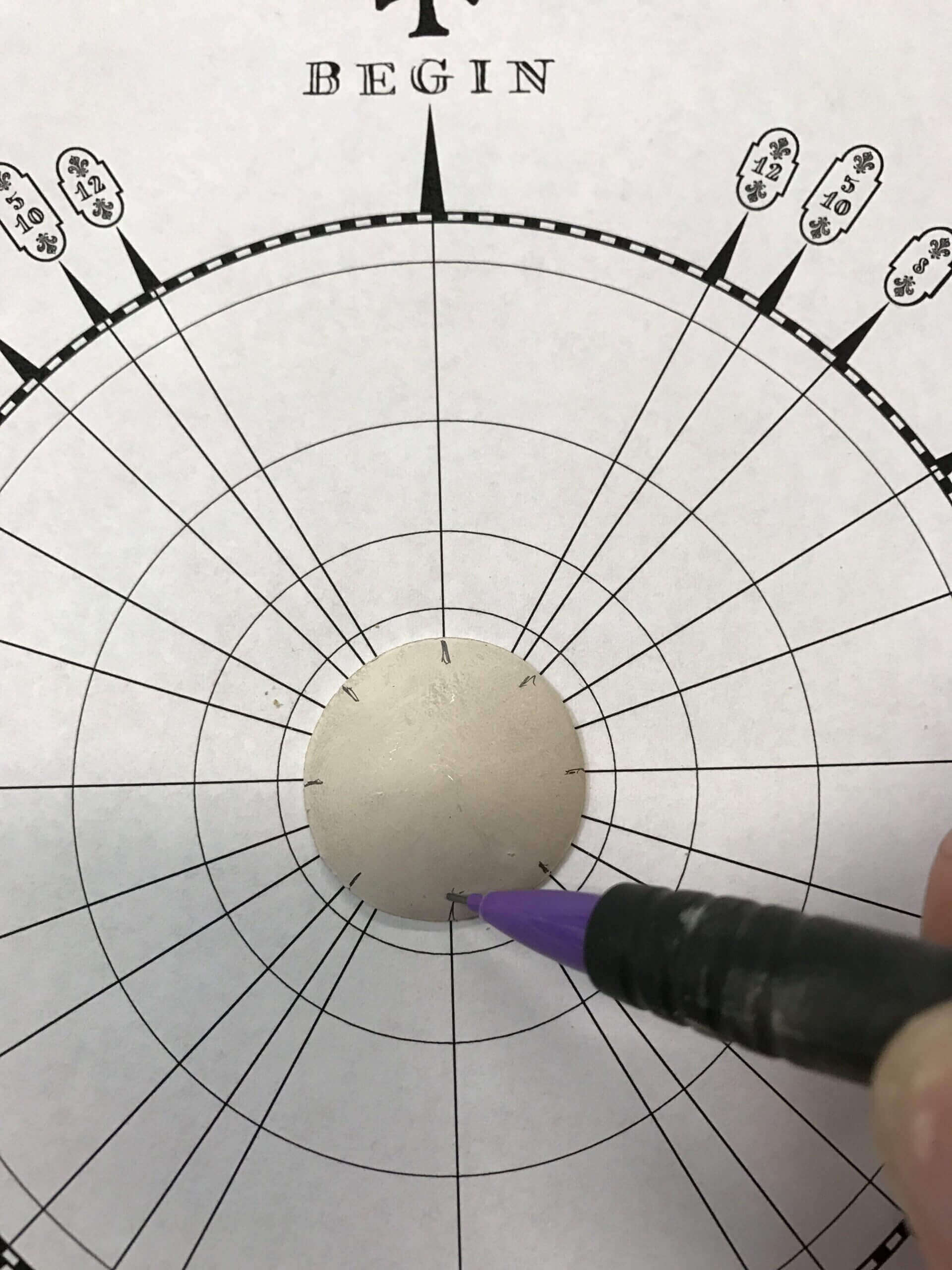 Target circle with a pen pointing center.